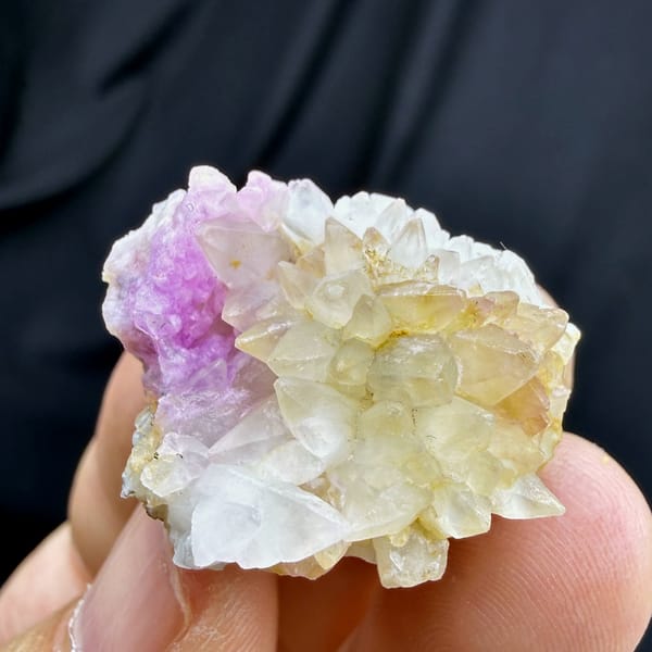Yellow dogtooth calcite with pink cobalt aragonite from Yunnan, China, close-up of the crystal faces