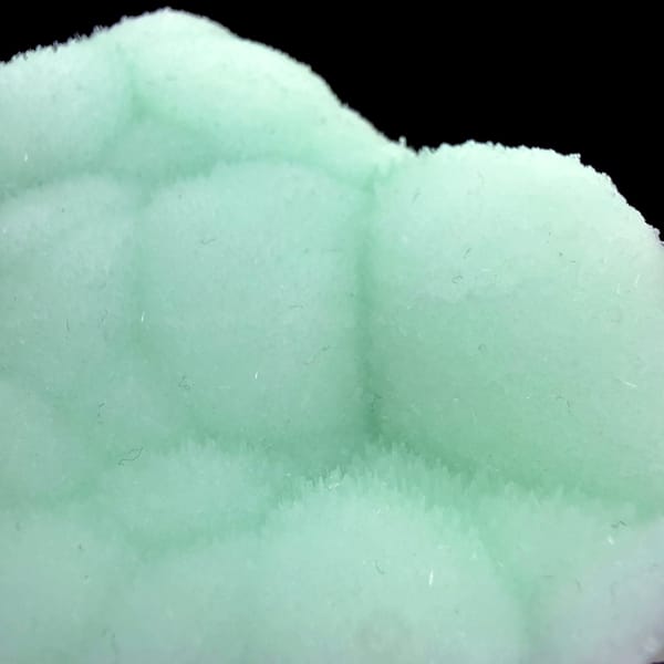Pastel-green botryoidal aragonite plate from Yunnan, China, reverse side