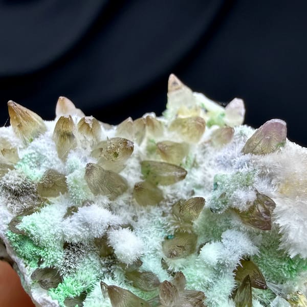 Amber dogtooth calcite with green copper minerals and aragonite from Yunnan, China, reverse side
