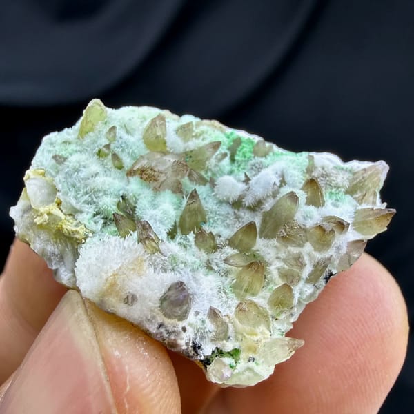 Amber dogtooth calcite with green copper minerals and aragonite from Yunnan, China, top view