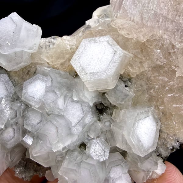 Hexagonal calcite crystals with champagne apophyllite from Fujian, China, close-up of the crystal faces