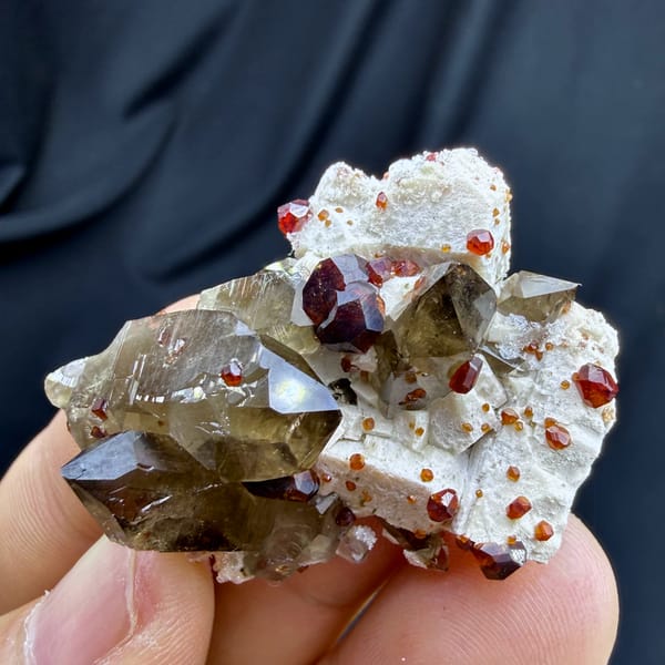 Smoky quartz with red garnets and hyalite opal on feldspar from Yunxiao, Fujian, China, reverse side