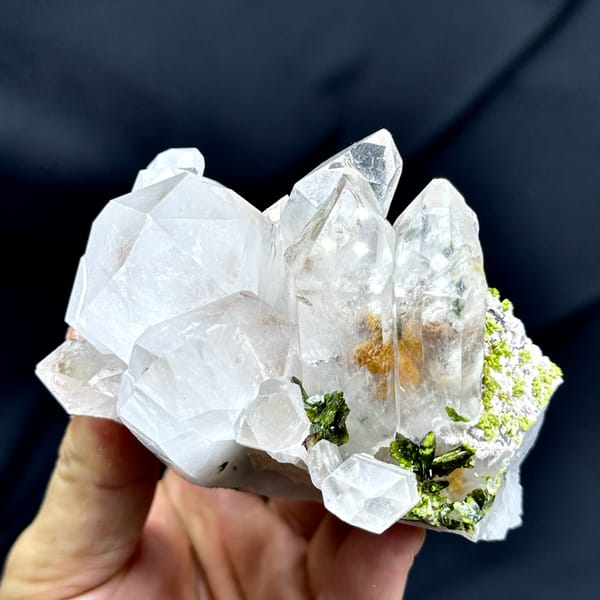 Large clear garden quartz crystals with green epidote from Sichuan, China, close-up of the crystal faces