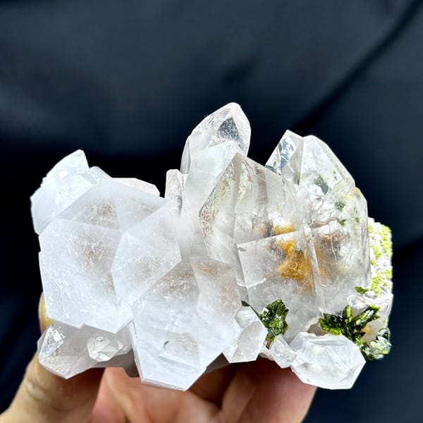 Large clear garden quartz crystals with green epidote from Sichuan, China, detail of the matrix contact