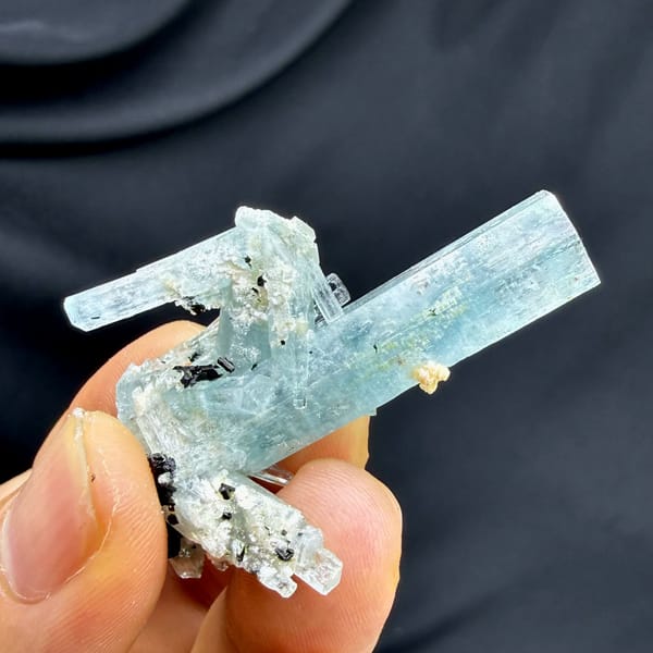 Sea-green aquamarine prism with black schorl on feldspar from Namibia, top view