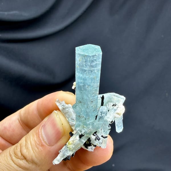 Sea-green aquamarine prism with black schorl on feldspar from Namibia, detail of the matrix contact