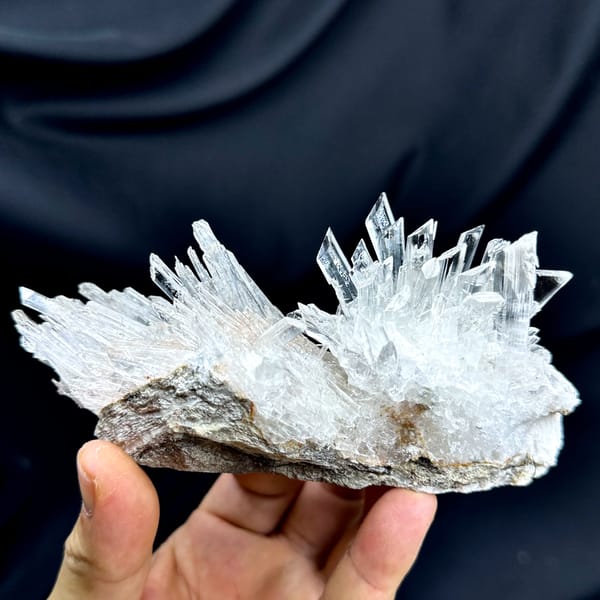 Long fan of transparent gypsum prisms from Guizhou, China, close-up of the crystal faces