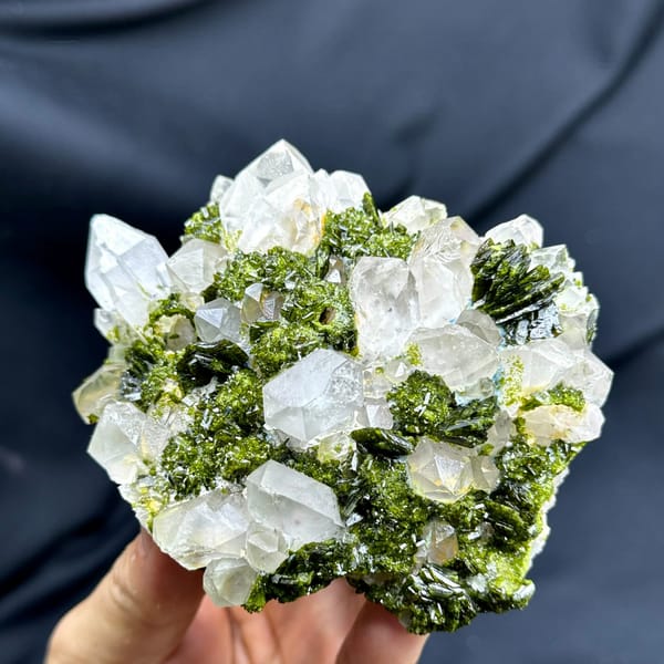 Green botryoidal epidote between milky garden quartz crystals from Sichuan, China, held in hand
