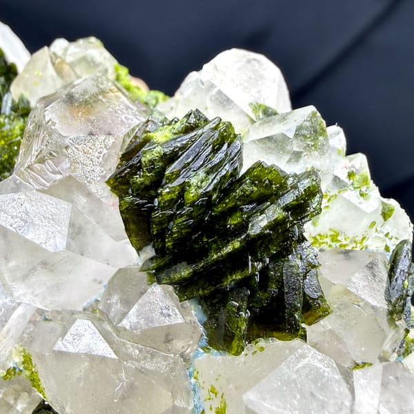 Green botryoidal epidote between milky garden quartz crystals from Sichuan, China, close-up of the crystal faces