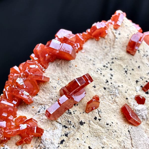 Fiery red vanadinite crystals on pale matrix from Morocco, close-up of the crystal faces