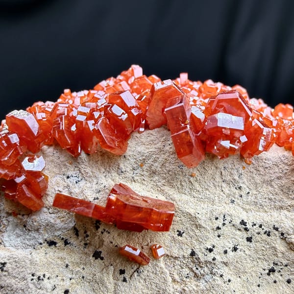 Fiery red vanadinite crystals on pale matrix from Morocco, reverse side