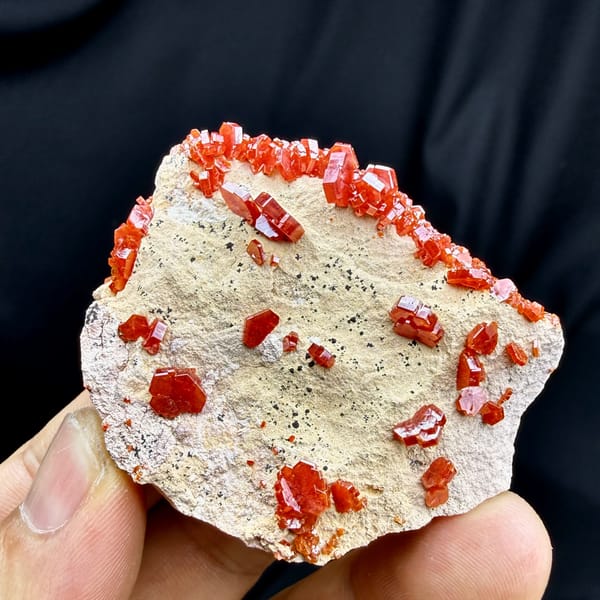 Fiery red vanadinite crystals on pale matrix from Morocco, top view