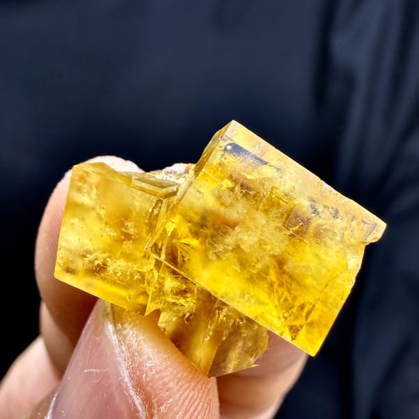 Glassy golden-yellow fluorite cube from Morocco, close-up of the crystal faces