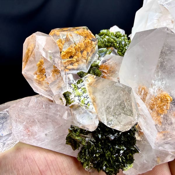 Large clear garden quartz crystals with green epidote from Sichuan, China, close-up of the crystal faces