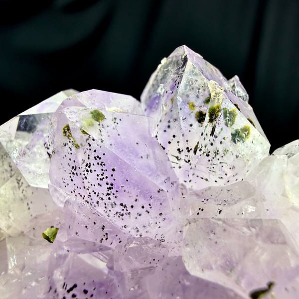 Rosette of pale purple-red garden quartz crystals from Sichuan, China, close-up of the crystal faces