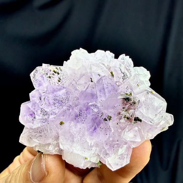 Rosette of pale purple-red garden quartz crystals from Sichuan, China, detail of the matrix contact