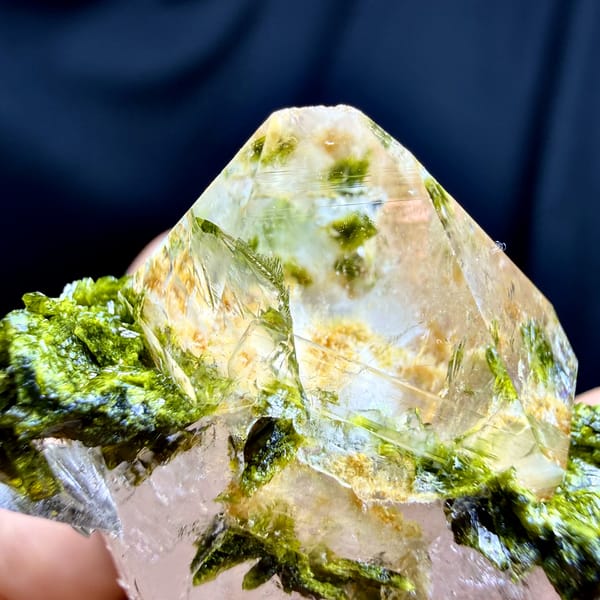 Double-terminated quartz crystal with yellow-green epidote collar from Sichuan, China, close-up of the crystal faces