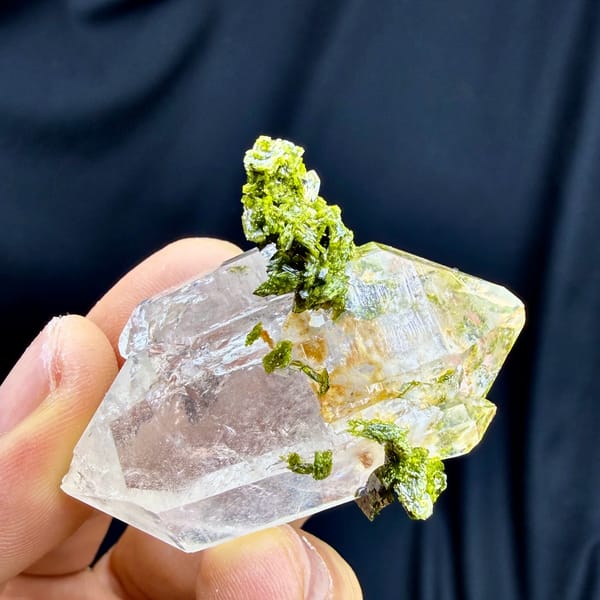 Double-terminated quartz crystal with yellow-green epidote collar from Sichuan, China, top view