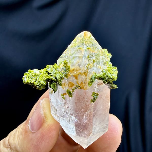 Double-terminated quartz crystal with yellow-green epidote collar from Sichuan, China, detail of the matrix contact