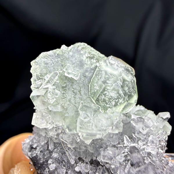 Flat green fluorite with clear quartz needles from Fujian, China, close-up of the crystal faces