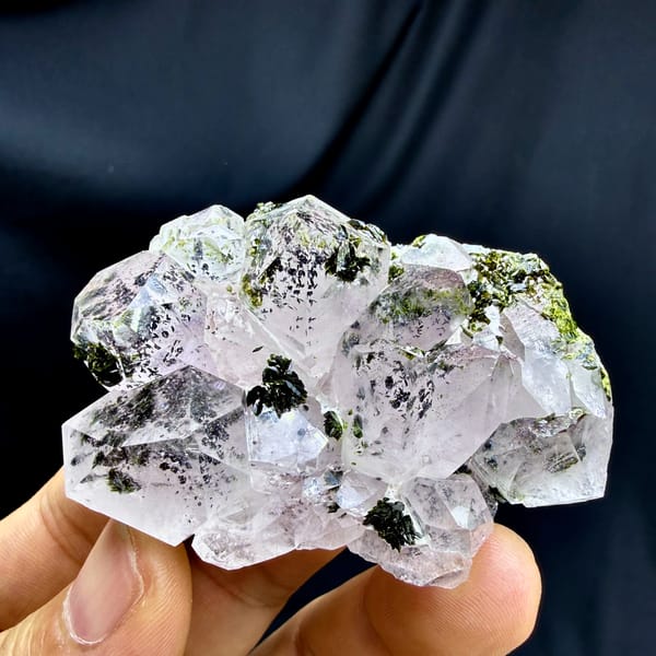 Clear garden quartz cluster with dark green epidote from Sichuan, China, close-up of the crystal faces