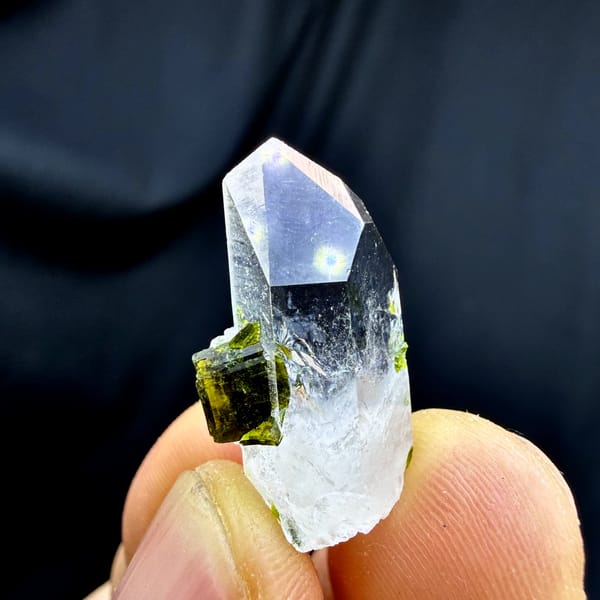 Small clear quartz point with green epidote from Sichuan, China, close-up of the crystal faces