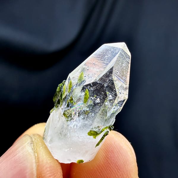 Small clear quartz point with green epidote from Sichuan, China, top view