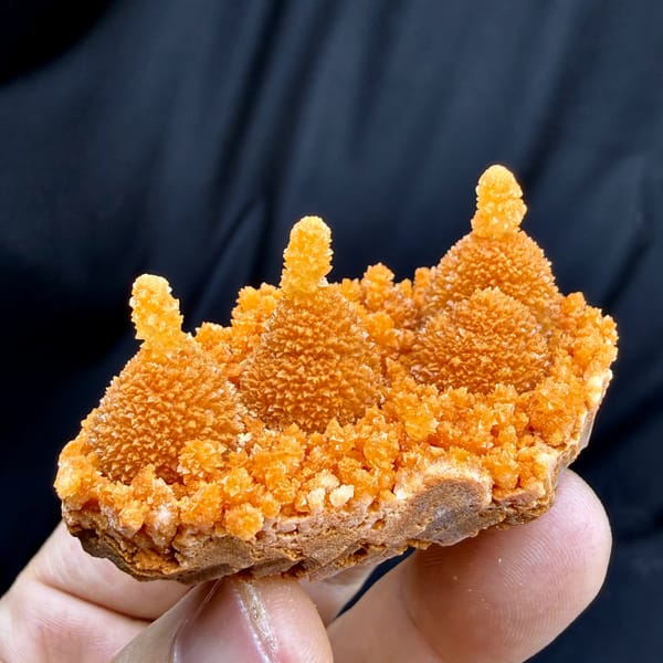 Orange gourd-shaped stalactitic calcite from Yunnan, China, close-up of the crystal faces