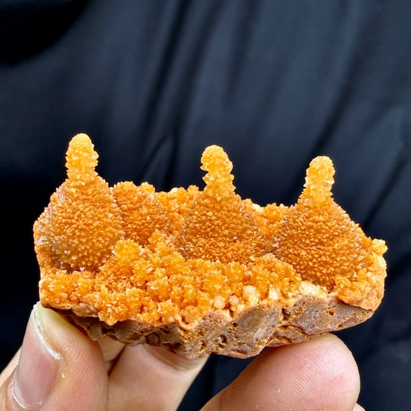 Orange gourd-shaped stalactitic calcite from Yunnan, China, top view