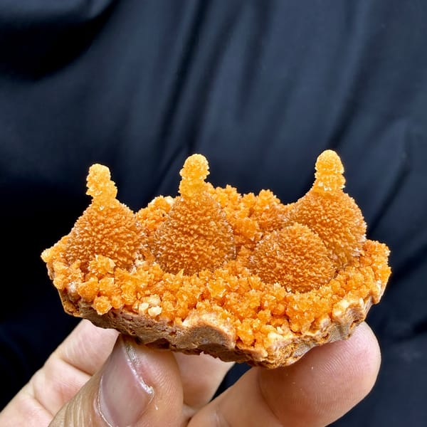 Orange gourd-shaped stalactitic calcite from Yunnan, China, detail of the matrix contact