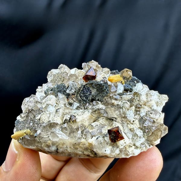 Red-brown helvine crystals on smoky quartz and feldspar from Yunxiao, Fujian, China