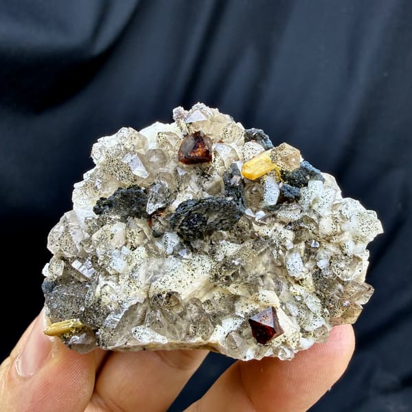 Red-brown helvine crystals on smoky quartz and feldspar from Yunxiao, Fujian, China, top view