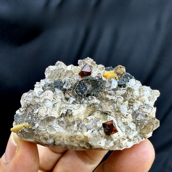 Red-brown helvine crystals on smoky quartz and feldspar from Yunxiao, Fujian, China, detail of the matrix contact