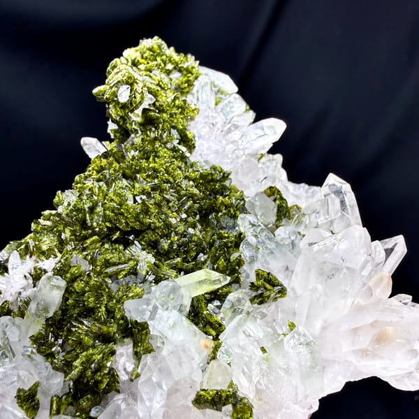 Wide clear quartz floater with green epidote carpet from Sichuan, China, top view