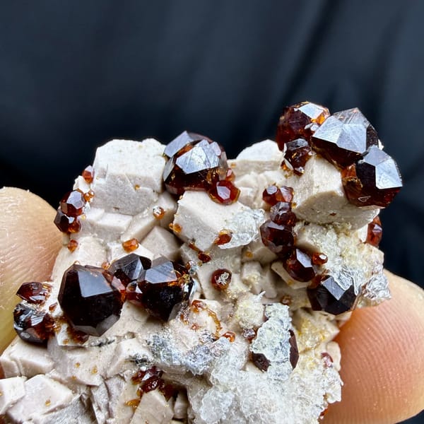 Glossy wine-red garnet crystals with hyalite opal on feldspar from Yunxiao, Fujian, China, top view