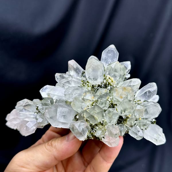 Flower-shaped fan of clear garden quartz with epidote from Sichuan, China, close-up of the crystal faces