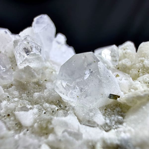 Pale pink feldspar crystal capped with quartz druse and mica from Pakistan, second angle