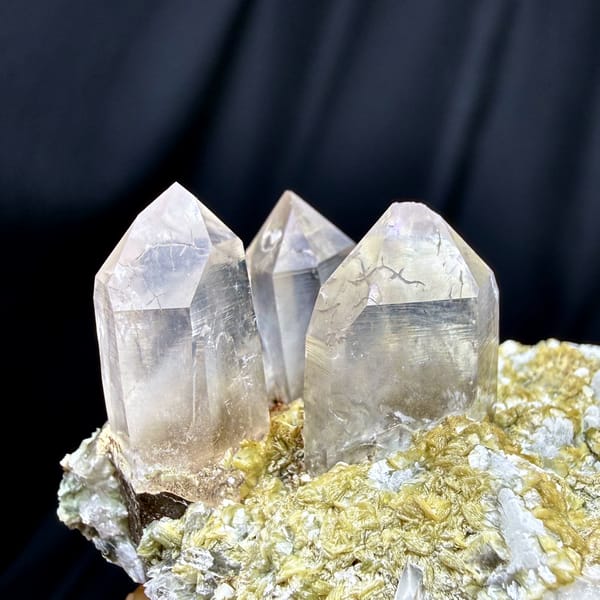 Gradient smoky quartz points on feldspar and mica from Yunxiao, Fujian, China, close-up of the crystal faces