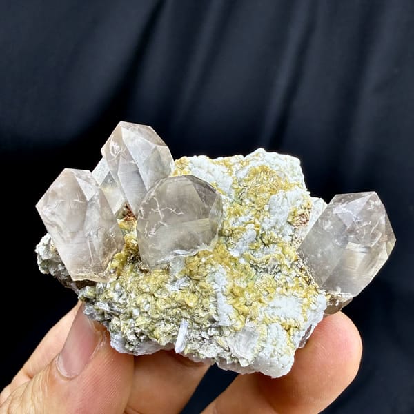 Gradient smoky quartz points on feldspar and mica from Yunxiao, Fujian, China, top view
