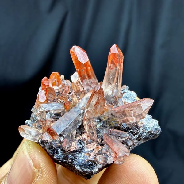 Red-skinned quartz needles on black specular hematite from Guangdong, China, reverse side