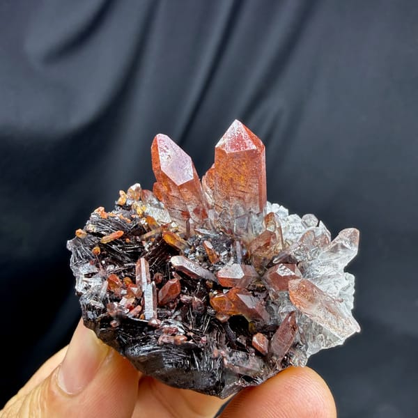 Red-skinned quartz points on specular hematite from Guangdong, China, second angle