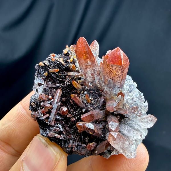 Red-skinned quartz points on specular hematite from Guangdong, China, reverse side