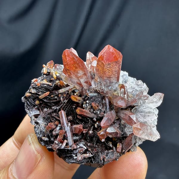 Red-skinned quartz points on specular hematite from Guangdong, China, detail of the matrix contact
