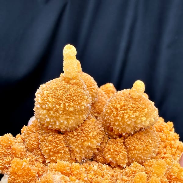 Orange gourd-shaped calcite stalactites from Yunnan, China, second angle