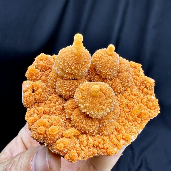 Orange gourd-shaped calcite stalactites from Yunnan, China, close-up of the crystal faces