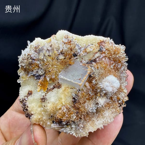 White-rimmed fluorite cube among golden creedite sprays from Guizhou, China, detail of the matrix contact