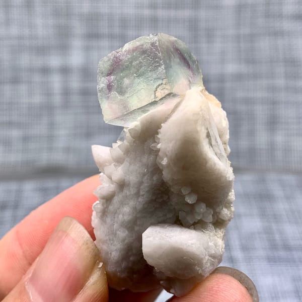 Purple-green fluorite cube on a pale quartz stalk from Inner Mongolia, China, reverse side