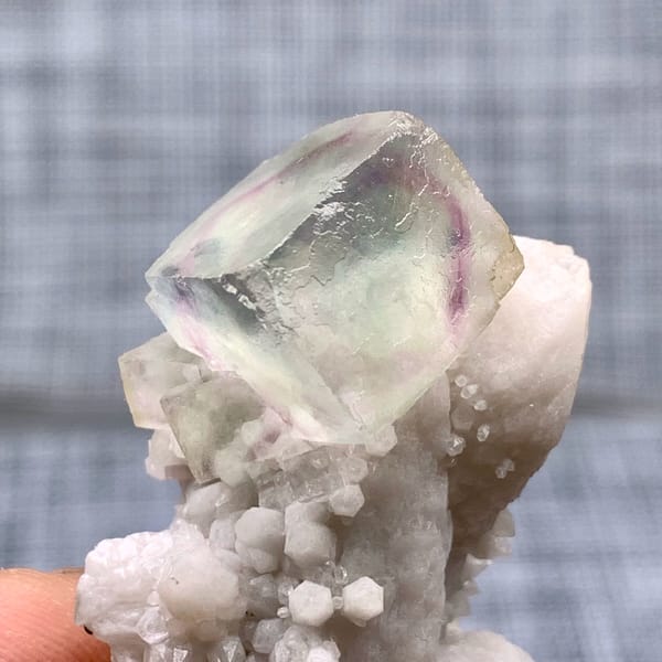 Purple-green fluorite cube on a pale quartz stalk from Inner Mongolia, China, top view