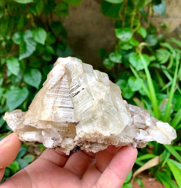Large cream adularia feldspar crystal from Pakistan, held in hand