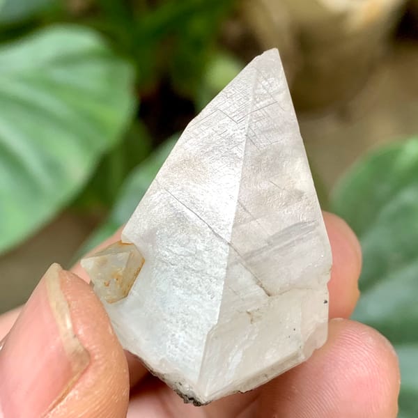 Milky calcite point with pale green fluorite octahedra from Fujian, China, top view